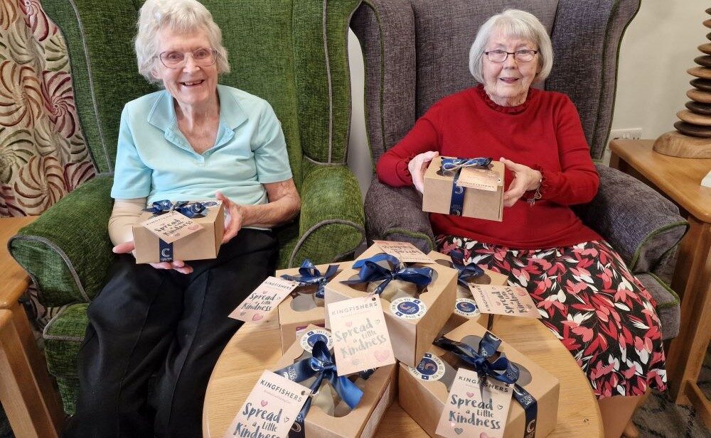 Kingfishers residents June Price, left, and Val Collinge with boxes of shortbread ready to distribute to community contacts.