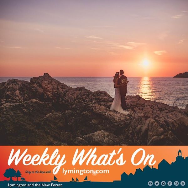 Bride and groom on rocks watching sunset Weekly What's On Lymington New Forest