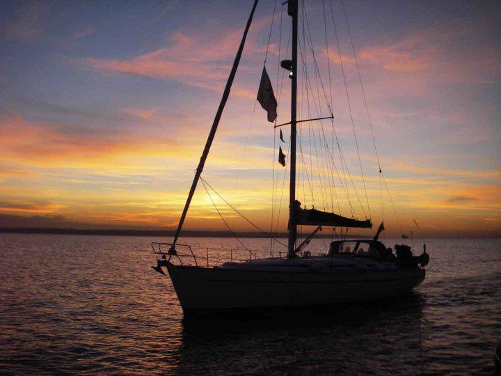 yacht at anchor at sunset