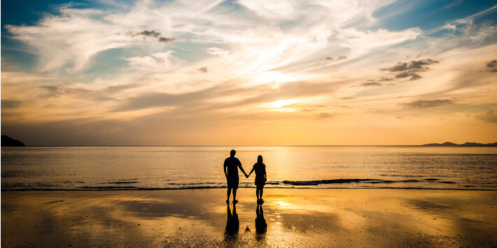 couple on beach into the sunset