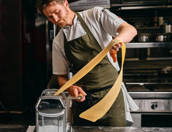 Chef prepares fresh pasta in kitchen